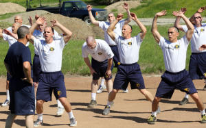 A basic recruit academy student, center,  takes a breather during fitness training  in the 151st class at the Alameda County Sheriffs Office Regional Training Center in Dublin, Calif., on Monday, March 17, 2014.  Academy graduates pass a rigorous physical fitness training program and are fit when hired by police departments around the state; however, very few departments require veteran officers to maintain a high level of fitness. (Jim Stevens/Bay Area News Group)
