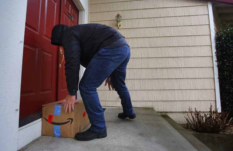 Detective on front porch with package decoy