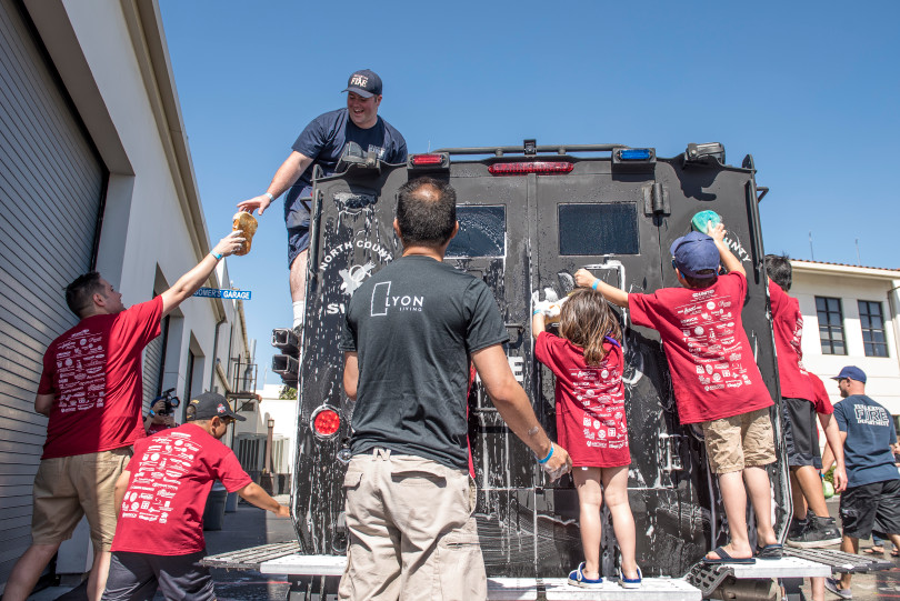 Volunteers of all ages are eager to climb onto the SWAT Bobcat vehicle while washing it for a service day along with a fleet of police cruisers in Fullerton on Saturday, April 29, 2017. (Photo by Matt Masin, Orange County Register, SCNG)
