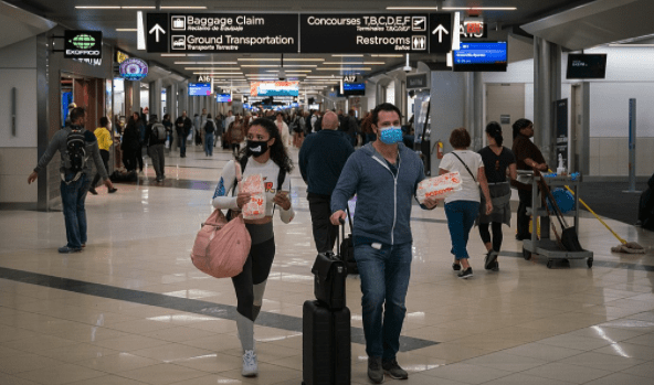 Travelers wearing masks try to reduce the risk of contracting coronavirus.  (Wikipedia)