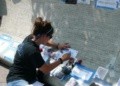 Katie sketching her father's name at the National Law Enforcement Memorial.