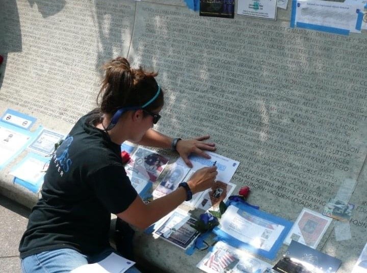 Katie sketching her father's name at the National Law Enforcement Memorial.