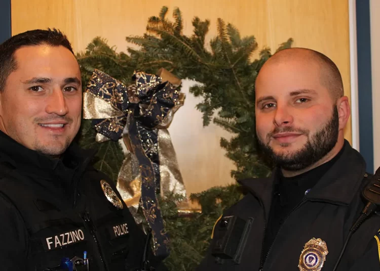 Officers Weston Fazzino (left) and Rob Schiffer (right) delivered several packages to their rightful homes in Lakeville, Massachusetts, last week. (Courtesy of Lakeville Police Department)