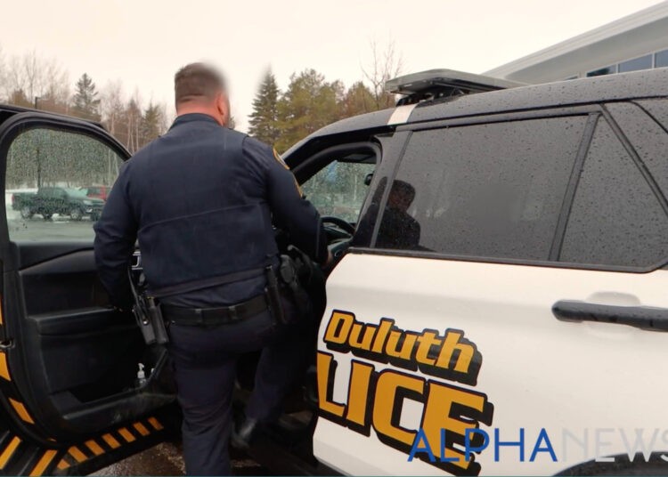 member of the Lake Superior Drug and Violent Crime Task Force enters his squad car during a recent shift. (Alpha News)