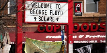 A "Welcome to George Floyd Square" sign at the intersection of East 38th Street and Chicago Avenue in March 2021. (Lorie Shaull/Flickr)