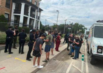 Police officers are served free ice cream by a retired cop after a local shop refused them service. (Bryan Ede Facebook)