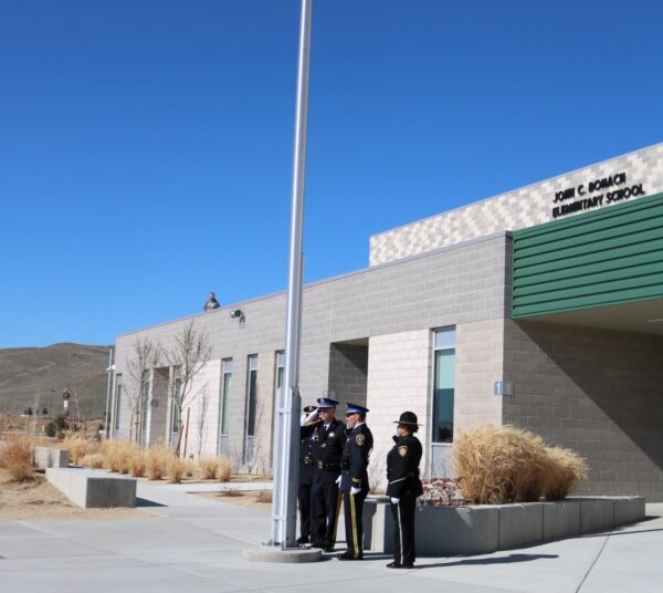 Police Honor Guard flag-raising ceremony at John C. Bohach Elementary School. Photo courtesy of the Nevada State Police Highway Patrol.)
